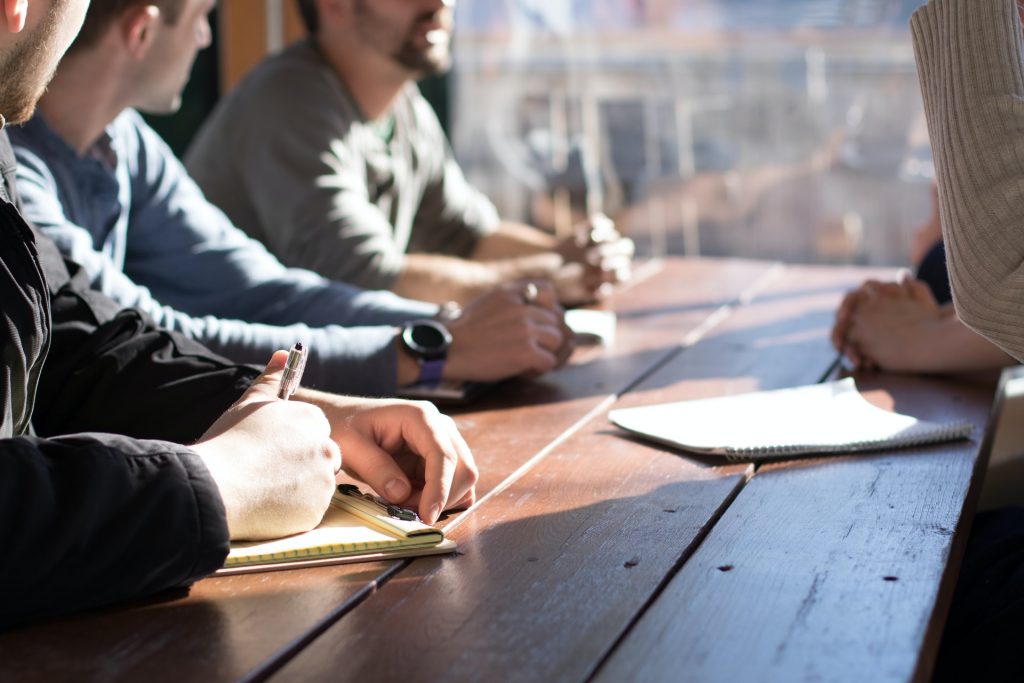 Three managers interviewing with a paper on desk