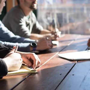 Three managers interviewing with a paper on desk